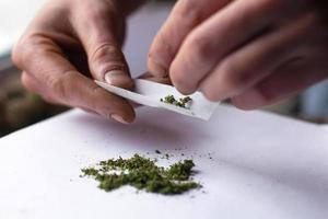 Torciendo la jamba con marihuana medicinal, primer plano del tratamiento con cannabis foto