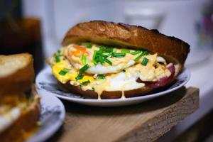 Homemade hot sandwich with egg, cheese and green onion photo