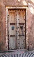 Antique rustic ancient wooden door. Architectural element. photo