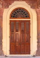 Antique rustic ancient wooden door. Architectural element. photo