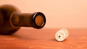 Wine cork and lying empty bottle on the table photo