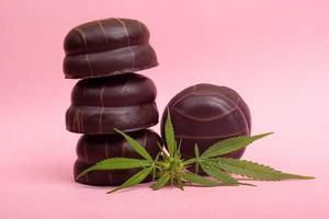 Chocolate marshmallows with THC content on pink background photo