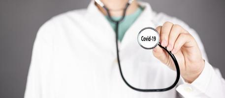 Doctor holds a stethoscope, concept of viral pandemic covid-19 photo