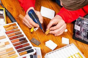 Master closes a scratch chipped on the laminate, restoration parquet with wax close-up photo