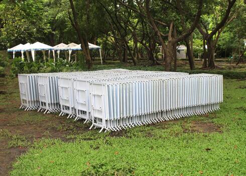 White row of chairs and tables in a garden photo