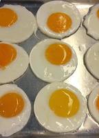 Fried eggs cooking on the container photo