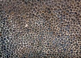 Gray sea pebble stone wall texture background photo