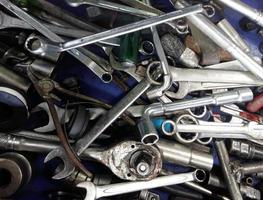 Dirty set of messy hand tools in the garage on a vintage background photo