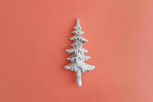 Beautiful silver Christmas tree close up isolated on a peach background photo