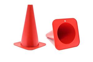 Red plastic cone with reflective stripes isolated on white background. Road cone signal photo