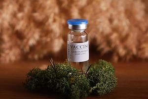 Vaccine selection. Ampoules with Covid-19 vaccine in laboratory. Fight the coronavirus sars-cov-2 pandemic. Glass vial medical close-up isolated on nature background photo