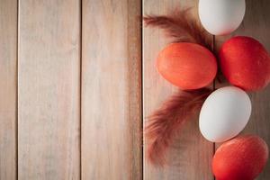 White and orange easter eggs on a light wooden background