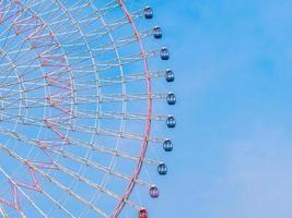 Ferris wheel in the park with blue sky background photo