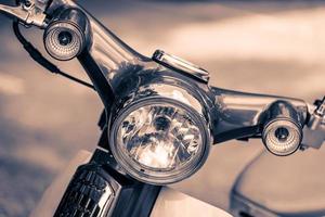 Vintage headlight lamp of a motorcycle photo