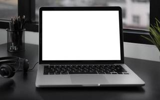 Laptop mock-up on dark desk photo