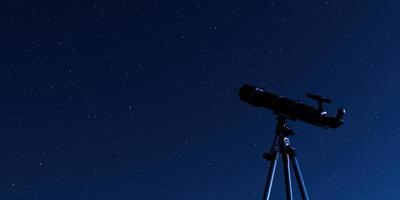 Telescope on tripod with a starry sky in the background, 3d rendering