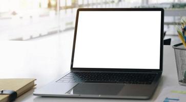 Laptop with a blank screen on a desk photo