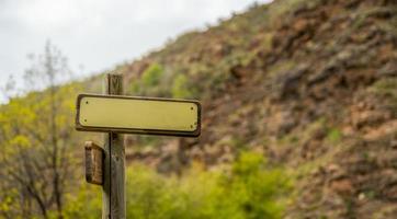 Mountain directional sign mockup with spider webs hanging