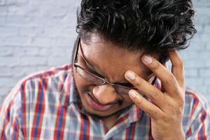 Young man suffering from a headache photo