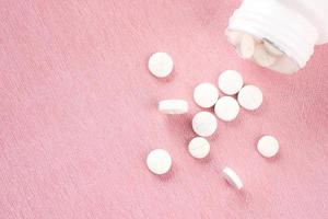 Pills on a pink background photo