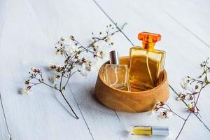 Perfume bottles in a wooden bowl photo