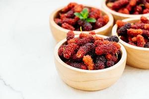 Black mulberry fruit in bowl photo