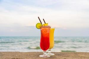 Iced cocktails drinking glass on the beach photo