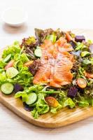 Raw Smoked salmon meat fish with fresh green vegetable salad photo