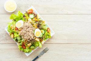 Tuna meat and eggs with fresh vegetable salad photo