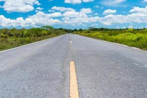 Small country road with blue sky background photo