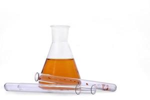 Laboratory flask with test tubes on white background photo