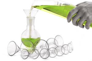 Laboratory funnels and flasks with hand photo