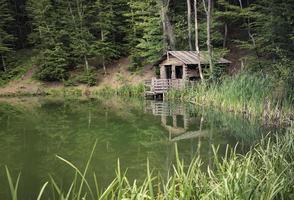 A cabin by a lake surrounded by trees in Yalta, Crimea photo