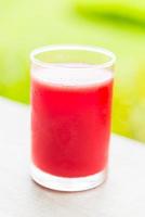 Watermelon juice glass with outdoor view background photo