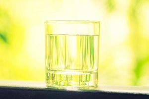 Water glass with outdoor view photo