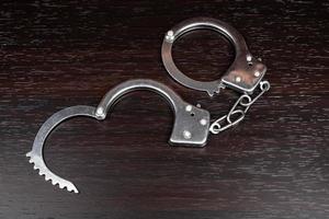 Handcuffs on a dark table photo
