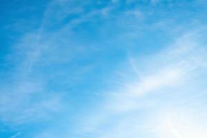 Blue sky with wispy clouds photo