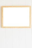 Blank photo frame on white wood wall background