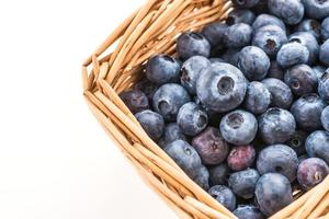 Blueberry basket isolated on white photo
