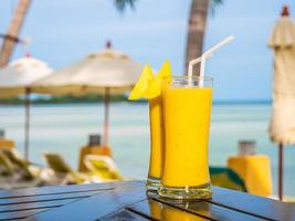 Glasses with mango smoothies photo