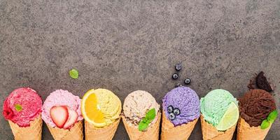 Flat lay ice cream cones collection on dark stone background photo