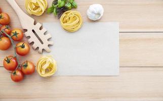 Ingredients for homemade pasta with copy space on wooden background photo