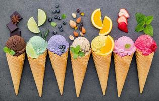 Flat lay ice cream cones collection on dark stone background photo