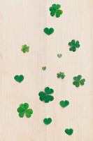 Close-up clover leaves setup on wooden background photo