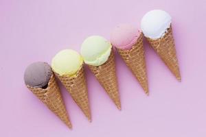 Flat lay of flavored ice cream on pink background