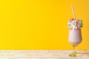 Front view of delicious milkshake on yellow background photo