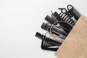 Hair tool set in paper bag on white background