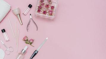 Arrangement of nail care accessories on pink background