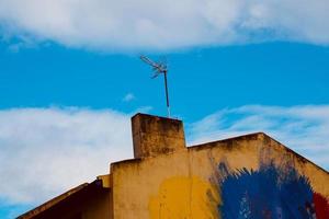 Television antenna on the rooftop of the house photo