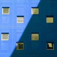 Window on the blue facade of the house, architecture in Bilbao city, Spain photo